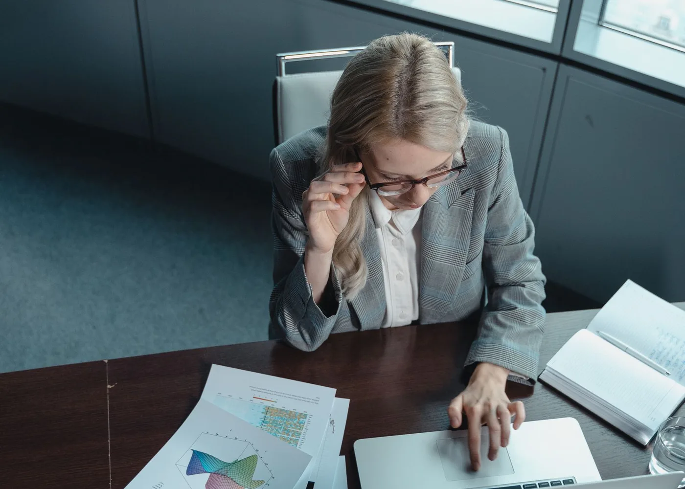 SEO analyst reviewing search and content performance data at a laptop